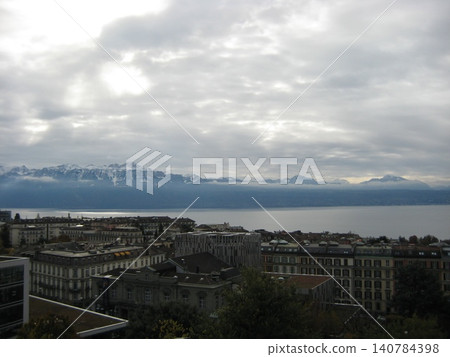 Lake Geneva in Lausanne in winter, with the French mountains on the opposite shore. Lake Geneva in Lausanne in winter, with the French mountains on the opposite shore. 140784398