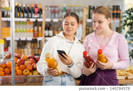 Young women scanning qr code for juices Young women scanning qr code for juices 140784578