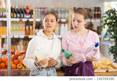 Young women choosing soda in grocery store 140784586