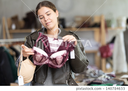 Young woman chooses underwear in clothing store Young woman chooses underwear in clothing store 140784633