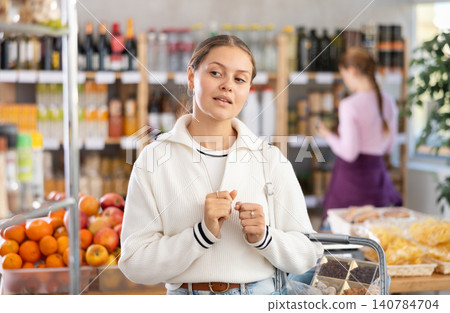 Young woman in supermarket Young woman in supermarket 140784704
