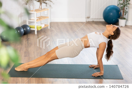Athletic woman takes various asana poses practicing yoga Athletic woman takes various asana poses practicing yoga 140784726