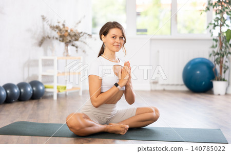 Slim woman doing yoga in Lotus pose in gym 140785022