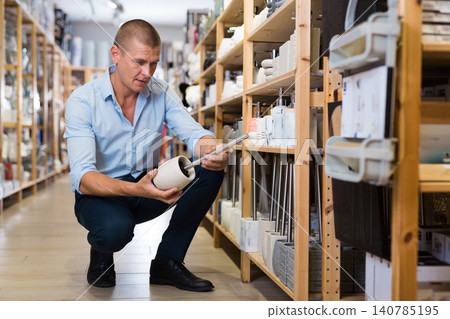 Man choosing toilet brush for bathroom 140785195