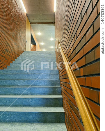 Modern Concrete Staircase with Wooden Handrail. 140785561
