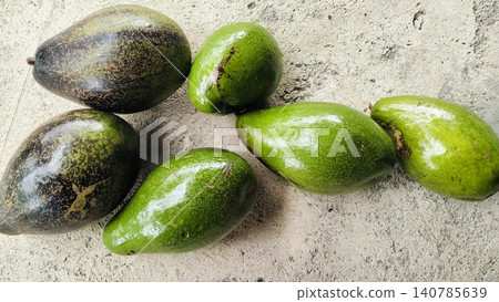 Fresh Whole Green and Ripe Avocados on Concrete Background Fresh Whole Green and Ripe Avocados on Concrete Background 140785639
