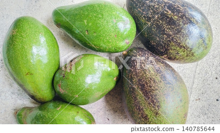Fresh Whole Green and Ripe Avocados on Concrete Background Fresh Whole Green and Ripe Avocados on Concrete Background 140785644