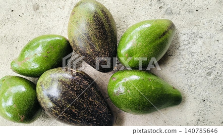 Fresh Whole Green and Ripe Avocados on Concrete Background Fresh Whole Green and Ripe Avocados on Concrete Background 140785646
