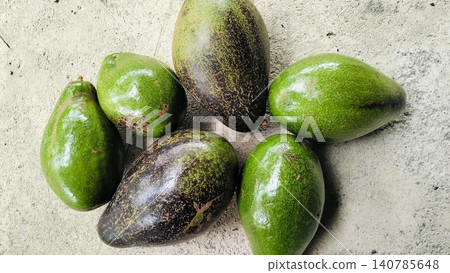 Fresh Whole Green and Ripe Avocados on Concrete Background Fresh Whole Green and Ripe Avocados on Concrete Background 140785648