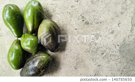 Fresh Whole Green and Ripe Avocados on Concrete Background Fresh Whole Green and Ripe Avocados on Concrete Background 140785650