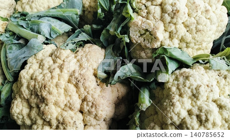 Fresh Raw Cauliflower Heads with Green Leaves on Market Stall 140785652