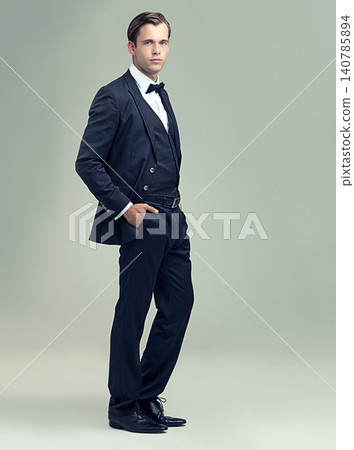 Man, studio and portrait with rich, vintage and class for retro style and fashion. Gentleman, spy or agent with tuxedo, suit and luxury with confidence for black tie isolated on white background Man, studio and portrait with rich, vintage and class for retro style and fashion. Gentleman, spy or agent with tuxedo, suit and luxury with confidence for black tie isolated on white background 140785894