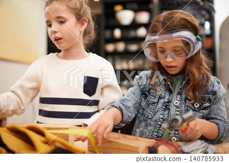 Play, game and girls with construction, wood and learning with fun or education with hobby or creative. Child development, friends or kids with tools or bonding together with hammer or safety glasses 140785933