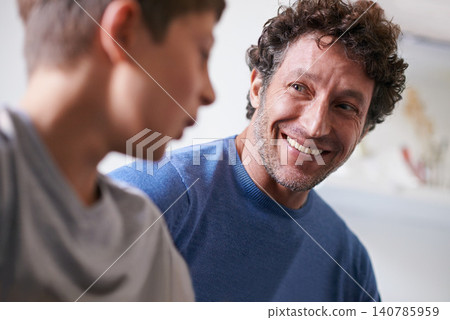 Home, son and father with smile, happiness and proud of child, growth and development of boy. House, adult and man listening to kid talk as parent with love, support and care for family in apartment Home, son and father with smile, happiness and proud of child, growth and development of boy. House, adult and man listening to kid talk as parent with love, support and care for family in apartment 140785959