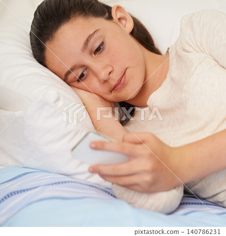Bed, teenager and girl with phone, games and play on app, digital and online on mobile. Bedroom, kid and female person with technology to relax, connectivity and internet for video or movie in house Bed, teenager and girl with phone, games and play on app, digital and online on mobile. Bedroom, kid and female person with technology to relax, connectivity and internet for video or movie in house 140786231
