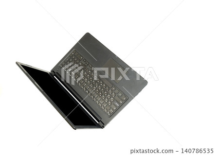 black open laptop is photographed from a top down angle on a clean white background 140786535