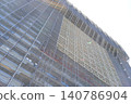 The geometric beauty of construction scaffolding stands out against the blue sky as large-scale repairs are underway. 140786904