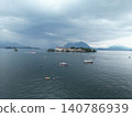 Overcast sky looms over calm lake waters 140786939