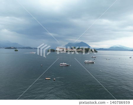Overcast sky looms over calm lake waters Overcast sky looms over calm lake waters 140786939