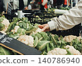 Fresh cauliflower and green leaves fill market display 140786940