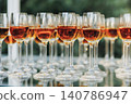 Rows of wine glasses gleam on a polished surface 140786947