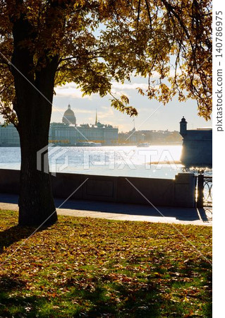 Isaac cathedral, Winter Palace, picturesque metal railings with a double-headed eagle and the crown of the Russian Empire on embankment in St. Petersburg, autumn sunset, incredible sun glare, Russia 140786975