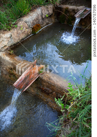 Rustic waterway conduit made of stone and tile Rustic waterway conduit made of stone and tile 140787096