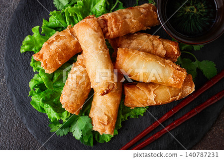 Pork nams, Vietnamese pancakes, rice paper stuffed, on black slate, with gnocchi sauce, no people Pork nams, Vietnamese pancakes, rice paper stuffed, on black slate, with gnocchi sauce, no people 140787231