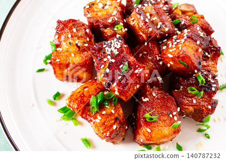 Chinese-style meat with sesame seeds and green onions, on a white plate, marble table, homemade, no people, Chinese-style meat with sesame seeds and green onions, on a white plate, marble table, homemade, no people, 140787232