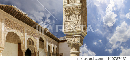 Arches in Islamic (Moorish) style (against the background of a beautiful sky with clouds) in Alhambra, Granada, Spain Arches in Islamic (Moorish) style (against the background of a beautiful sky with clouds) in Alhambra, Granada, Spain 140787481