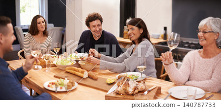 Bonding, eating and family at dinner in dining room for party, celebration or event at modern home. Smile, happy and group of people enjoying meal, supper or lunch together with wine at house. Bonding, eating and family at dinner in dining room for party, celebration or event at modern home. Smile, happy and group of people enjoying meal, supper or lunch together with wine at house. 140787733
