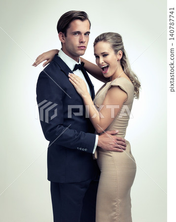 Couple, studio and portrait with smile, rich and vintage for luxury retro romance. Man, woman and model with tuxedo, glamour and confidence for classy black tie event isolated on white background Couple, studio and portrait with smile, rich and vintage for luxury retro romance. Man, woman and model with tuxedo, glamour and confidence for classy black tie event isolated on white background 140787741
