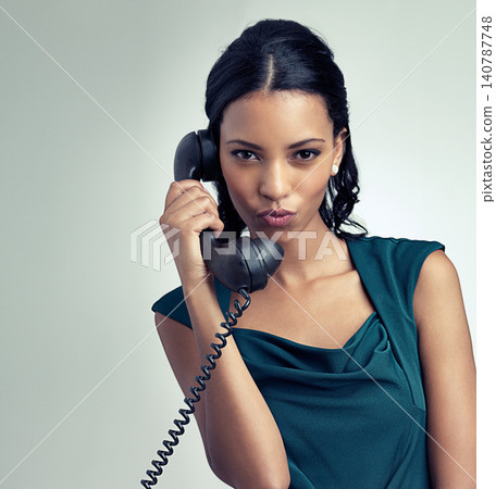 Portrait, receptionist and business woman on telephone with person pouting in studio isolated on a gray background mockup. Face, landline and secretary on call for communication on retro technology Portrait, receptionist and business woman on telephone with person pouting in studio isolated on a gray background mockup. Face, landline and secretary on call for communication on retro technology 140787748