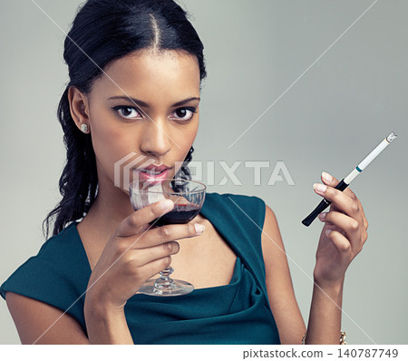 Woman, studio and portrait with wine, cigarette and fashion with luxury class and proud. Model, vintage and elegance with confidence, trendy and art deco or formal style isolated on white background Woman, studio and portrait with wine, cigarette and fashion with luxury class and proud. Model, vintage and elegance with confidence, trendy and art deco or formal style isolated on white background 140787749