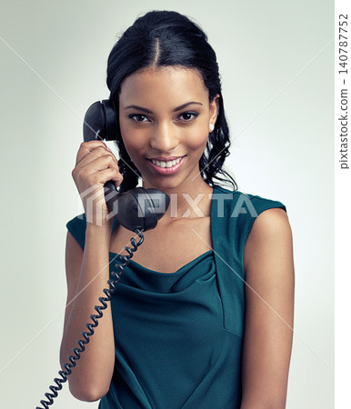 Portrait, happy and business woman on telephone in studio isolated on a gray background. Face, landline and secretary on call for communication or receptionist listen to conversation on retro tech Portrait, happy and business woman on telephone in studio isolated on a gray background. Face, landline and secretary on call for communication or receptionist listen to conversation on retro tech 140787752