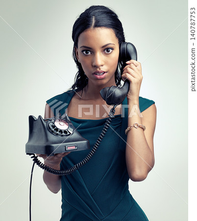 Portrait, telephone and woman with fashion, vintage style and confident on a white studio background. Face, person and model with retro phone and calling with elegant clothes and glamour with luxury Portrait, telephone and woman with fashion, vintage style and confident on a white studio background. Face, person and model with retro phone and calling with elegant clothes and glamour with luxury 140787753