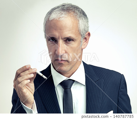 Portrait, mature and businessman smoking cigarette with salesman in studio isolated on a gray background. Face, suit and serious man with tobacco, ceo and manager with vintage fashion in Australia Portrait, mature and businessman smoking cigarette with salesman in studio isolated on a gray background. Face, suit and serious man with tobacco, ceo and manager with vintage fashion in Australia 140787785