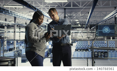 Software development team monitors data center metrics on a digital device to improve equipment performance. Software development team monitors data center metrics on a digital device to improve equipment performance. 140788561