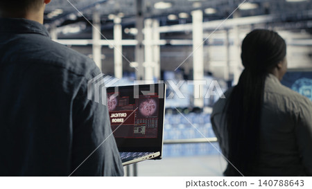Server room specialist reacts to a critical error popup while troubleshooting AI software and infrastructure downtime. 140788643