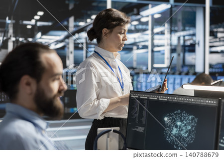 Data center team uses a desktop computer in a data center to manage AI virtualization and optimize server infrastructure. Data center team uses a desktop computer in a data center to manage AI virtualization and optimize server infrastructure. 140788679