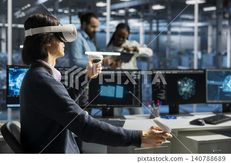 Software developer uses a VR headset in a data center to manage AI systems, train neural networks, and configure hardware. 140788689