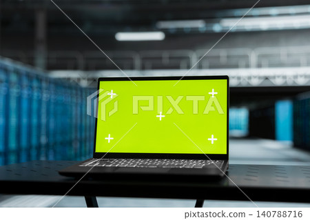 Green screen laptop in a data center supports failure detection, screen replacement, and editable monitoring workflows. Green screen laptop in a data center supports failure detection, screen replacement, and editable monitoring workflows. 140788716