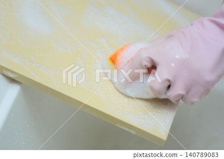 A housewife's hands washing a cutting board A housewife's hands washing a cutting board 140789083