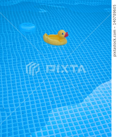 Classic yellow rubber duck floating in the pool. Classic yellow rubber duck floating in the pool. 140789605