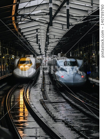 The One Piece Shinkansen shines brilliantly on a rainy day, parked side-by-side at Shin-Osaka Station. The One Piece Shinkansen shines brilliantly on a rainy day, parked side-by-side at Shin-Osaka Station. 140789760