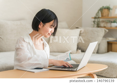 Middle school and high school girls studying at home using a computer. Middle school and high school girls studying at home using a computer. 140790139