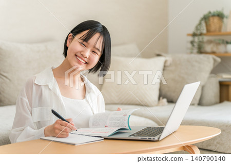 Middle school and high school girls studying at home using a computer. 140790140