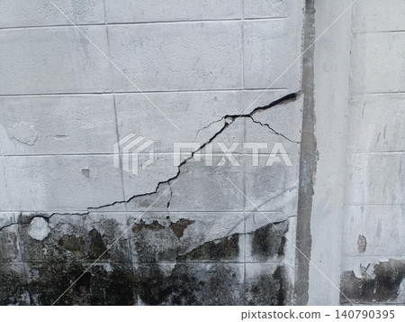 Crack wall concrete damage stain on gray block surface with moisture mark 140790395