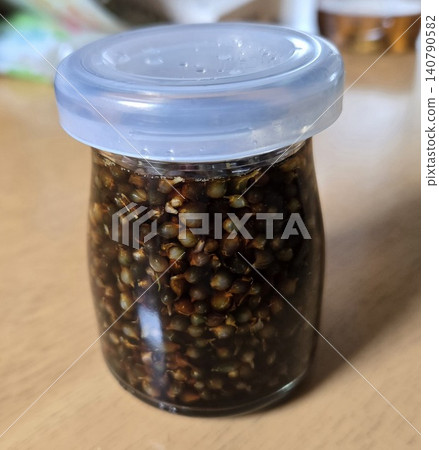 Homemade pickled wild onion bulbs in soy sauce, preserved in a small glass jar. Homemade pickled wild onion bulbs in soy sauce, preserved in a small glass jar. 140790582