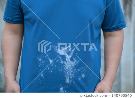 white flour or chalk stain on a blue shirt. Housework accident or dirty clothing concept. 140790840